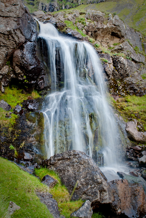 A long exposure HDR shot of a small waterfall.