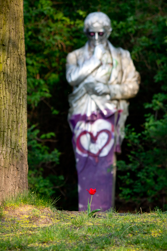 Statue: Statue and flower.